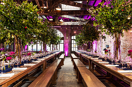Long tables with place settings and plants at our New York City event venues.