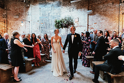 Bride and groom walking in our New York City wedding venue.