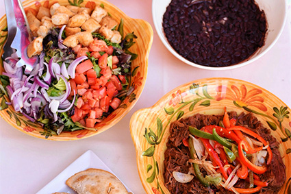 Salad, beans, meat, and empanadas, some of the many items available with our SoHo, New York City food catering services.