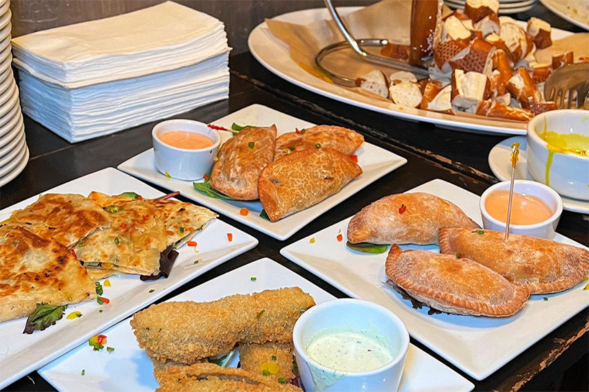 Bavarian pretzel and plates of empanadas served at our SoHo holiday event venue.