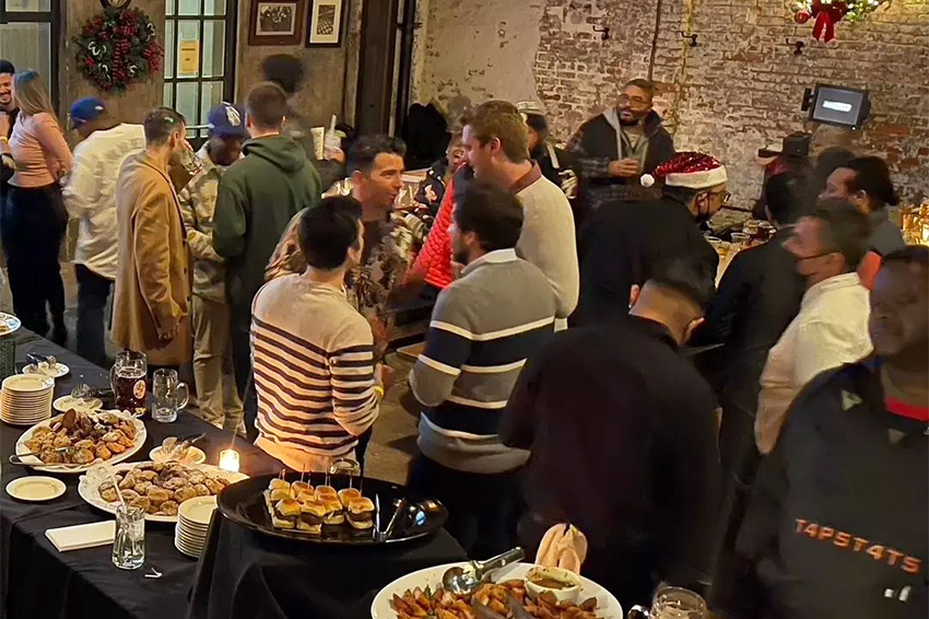 People mingling in small groups at our company holiday event venue near SoHo.
